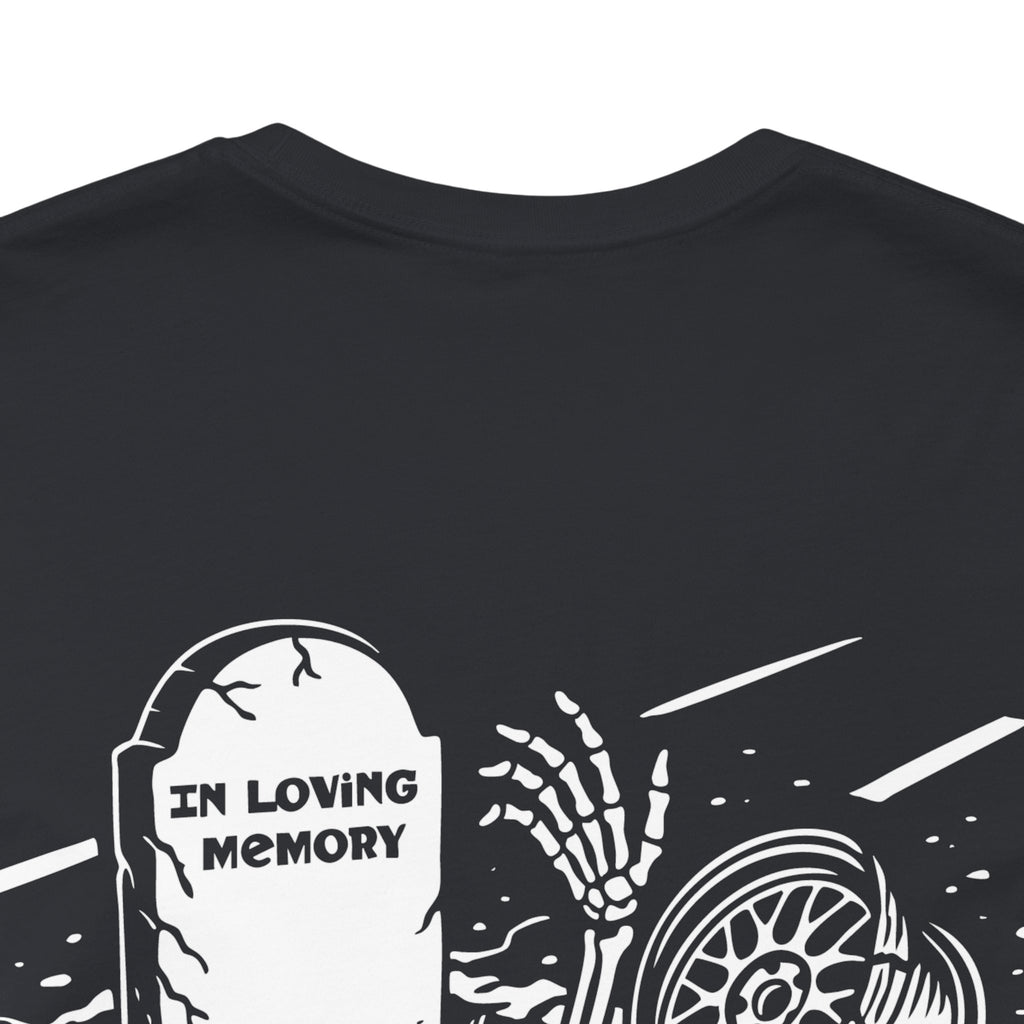 Black t-shirt with white graphic design of a skeleton hand reaching over a tombstone with 'In Loving Memory' text.